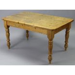 A solid pine refectory dining table with rounded corners to the plain rectangular top, & on turned &