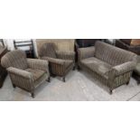 An Edwardian three-piece lounge suite, comprising a two-seater drop-end settee upholstered multi-