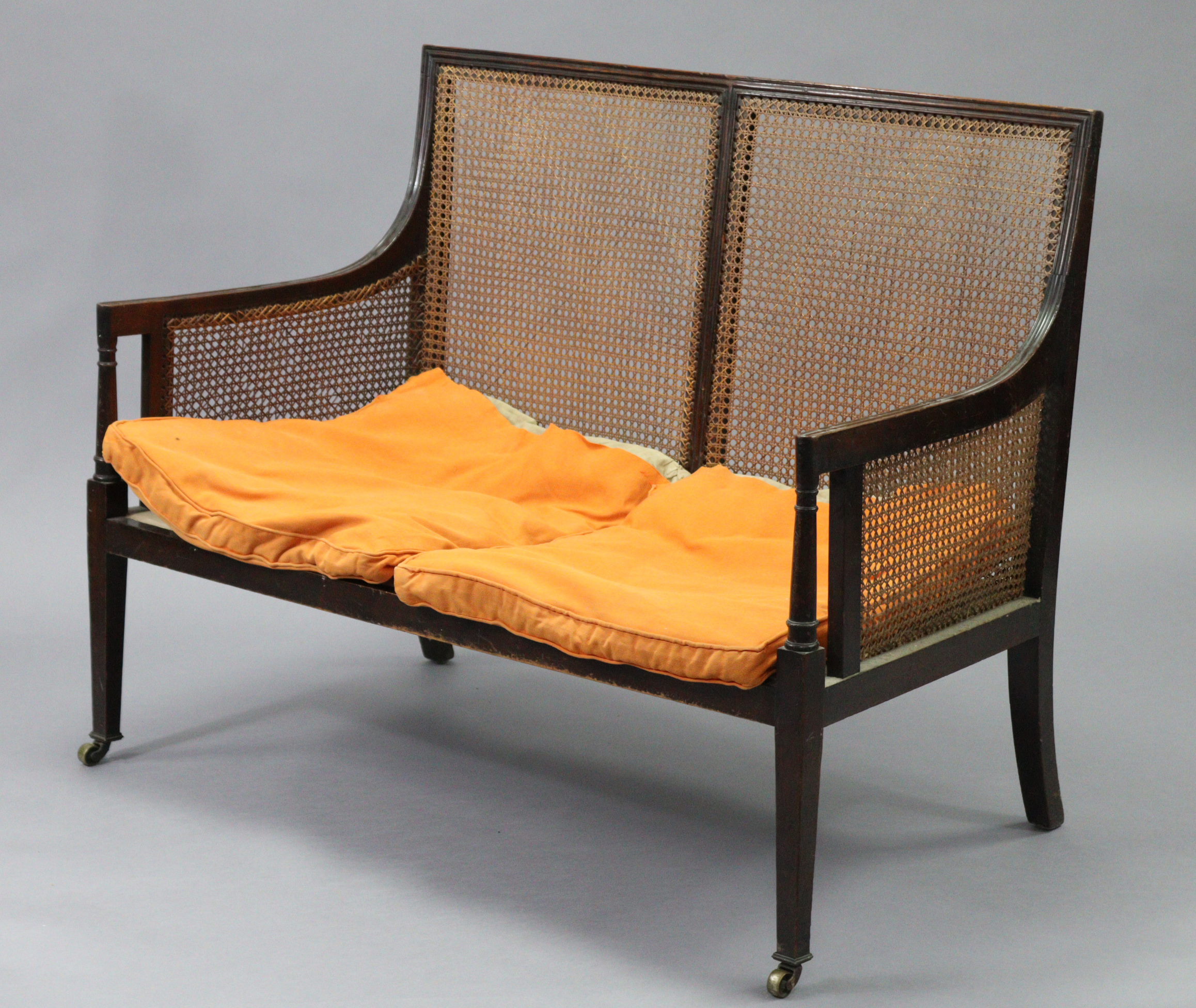 A mahogany two seater bergere settee in the late George III style, with moulded edges, turned arm - Image 2 of 8