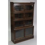 A Globe Wernicke-type oak bookcase of four stacking graduated tiers, each enclosed by pair of glazed