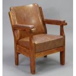 A mid-20th century armchair with padded seat, open arms & back upholstered brass-studded pigskin, on