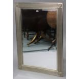 A modern rectangular wall mirror in silver-painted reeded frame, inset bevelled glass panel, 31” x