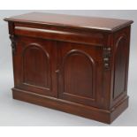 A mid Victorian-style mahogany finish rectangular side cabinet, fitted cushion-fronted frieze drawer