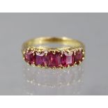 A RUBY RING set five graduated square-cut stones, the largest approx. 4mm x 4mm, to an un-marked