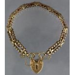 A 9ct. gold flexible bracelet of fancy gate links, with engraved padlock clasp; 7” long. (13.1gm).