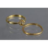 A yellow metal ring set single diamond; size: P; weight: 3gm.; & a 22ct. gold band; size: N; weight: