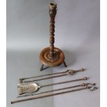 A 19th century beech floor-standing candle light with turned column, on circular base with three st