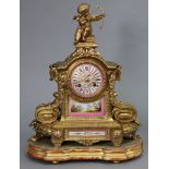 A 19th century French mantel clock in gilt speltre rococo-style architectural case with cherub