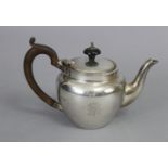 A George V silver “bachelor’s” teapot of plain rounded form, with wood handle, hinged lid, &