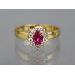 A gold ring set oval ruby within a border of ten small diamonds. Size: Q; weight: 3.2gm.