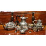 A silver-plated four piece tea service of oblong semi-fluted form; a round semi-fluted three piece