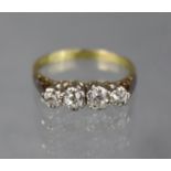 A diamond ring set four small graduated stones, the shank marked: “18ct. & Plat”; size: I/J;