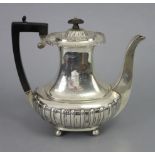 A George V silver coffee pot of semi-fluted oblong form, with ebonised handle & finial, engraved