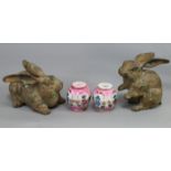 A pair of Japanese bronzed cast iron models of rabbits, 4¾” & 3½” high; & a pair of pink-ground