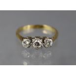 A diamond ring set three graduated stones, the largest approx. 0.25 carat, set to a yellow metal