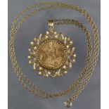 A George V sovereign pendant, loose-mounted within a 9ct. gold border of pierced heart design, on