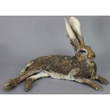 NICK MACKMAN. A contemporary ceramic sculpture titled: “Lying Down Hare”, glazed in naturalistic