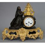 A 19th century French mantel clock in ebonised & gilt speltre figural case with pierced rococo style
