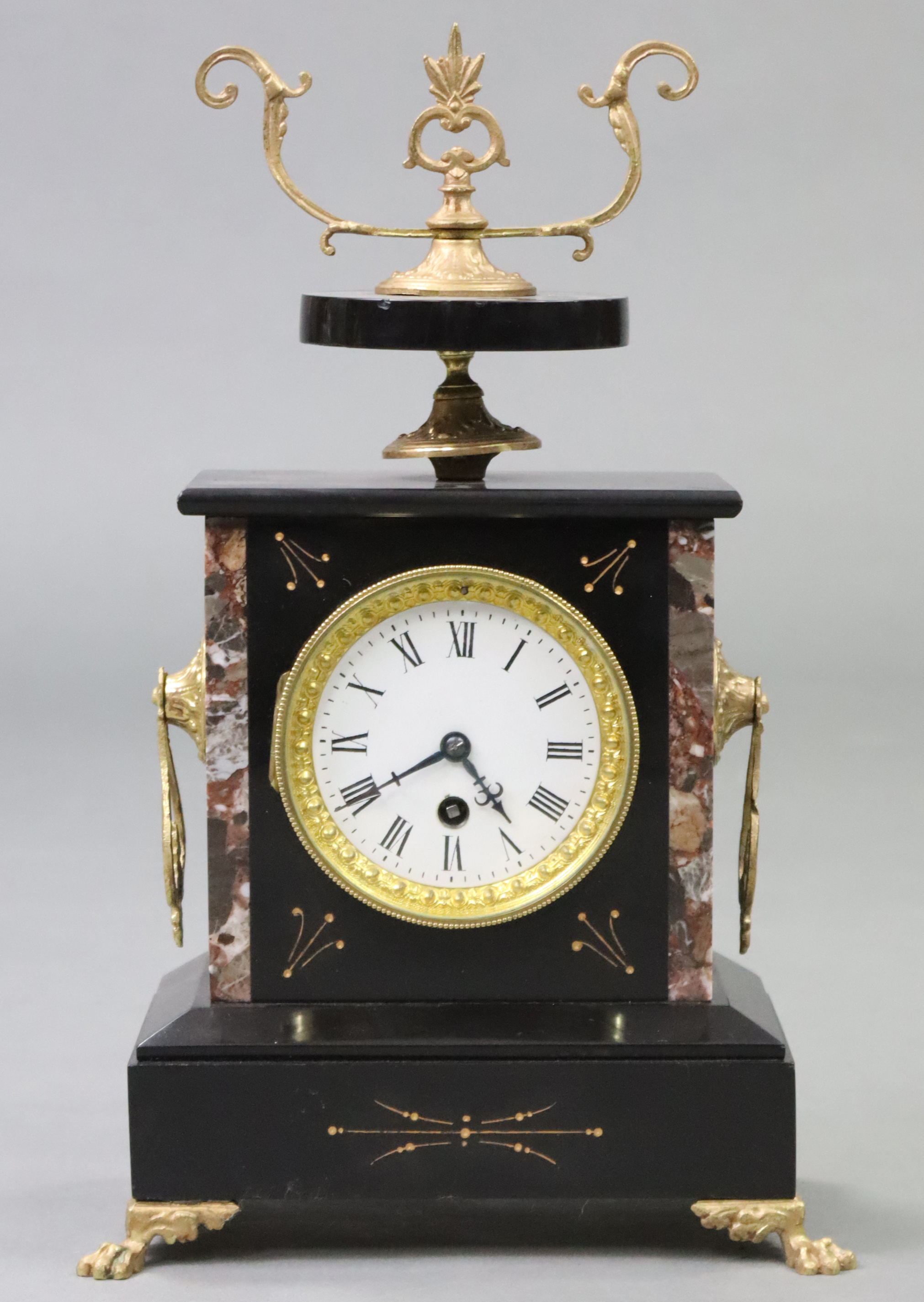 A Victorian mantel clock in black slate & rouge marble case, with gilt-metal mounts, 3½” diam. white