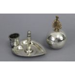 A late Victorian silver heart-shaped cigar ashtray with central pillar-shaped cigar-cutter, a