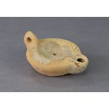 An ancient Roman terracotta oil lamp, 4¼” x 2” high; with certificate of authenticity.