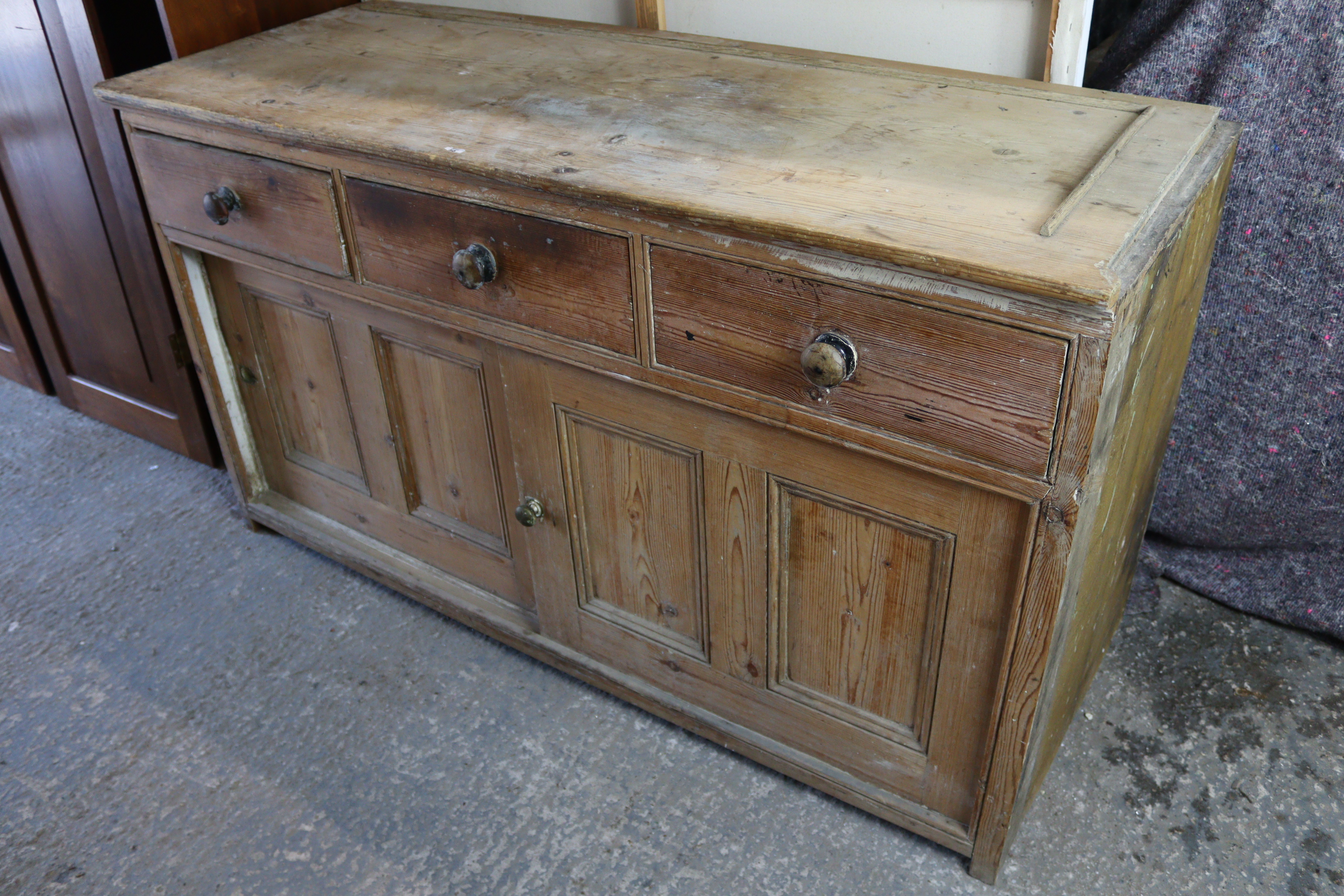 A pine dresser base, fitted three frieze drawers above cupboard enclosed by pair of sliding panel - Image 2 of 5