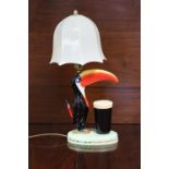 A Carlton ware Guinness Toucan table lamp with shade (GA/2178).