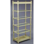 A cream painted wooden tall six-tier whatnot with turned supports, 30” wide x 72” high.