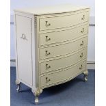 A continental-style cream & gilt finish serpentine-front chest, fitted five long graduated drawers