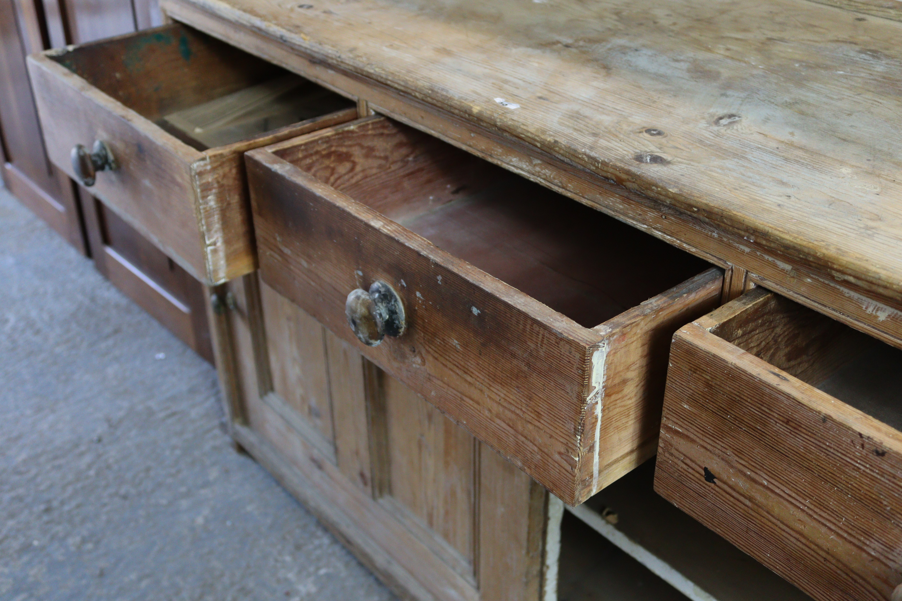 A pine dresser base, fitted three frieze drawers above cupboard enclosed by pair of sliding panel - Image 4 of 5