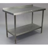 A stainless steel rectangular two tier kitchen work bench on square legs, 47” long x 36” high.