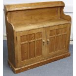 A pine side cabinet, with open shelf to the low-stage panel back above cupboard enclosed by pair