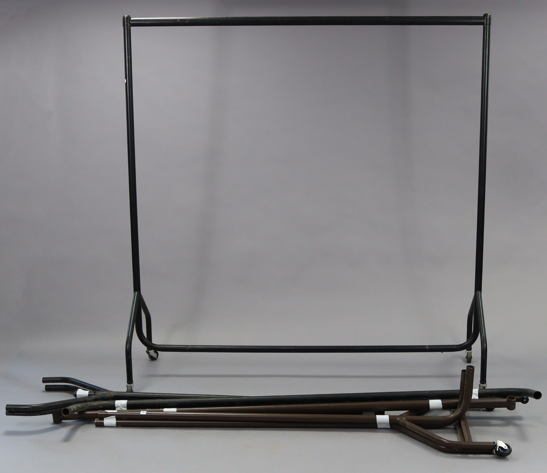 Three tubular-metal clothes rails – various sizes.