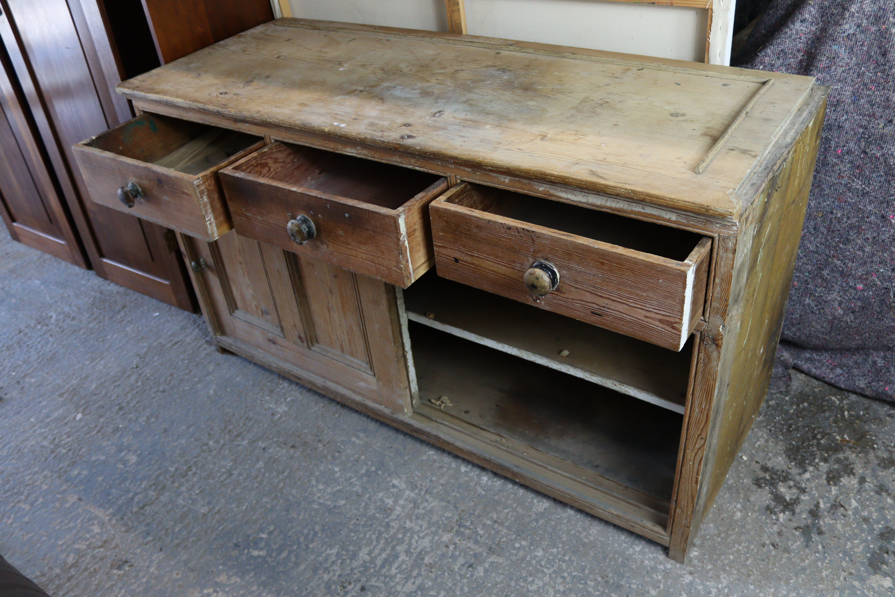 A pine dresser base, fitted three frieze drawers above cupboard enclosed by pair of sliding panel - Image 3 of 5