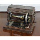 A Singer hand sewing machine with walnut case.