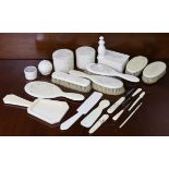 An ivory eight-piece dressing table set, each piece with carved big cat decoration; together with