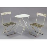A white painted aluminium garden table with circular top, & on square fold-away legs, 23½”