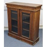 A late Victorian walnut small display cabinet, with three adjustable shelves enclosed by pair of