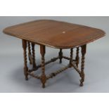 A 1930’s oak gate-leg dining table with carved wagon-wheel border, & on barley-twist legs & turned