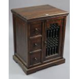 A hardwood dwarf cabinet, fitted centre shelf to the right-hand side enclosed by iron grille door,