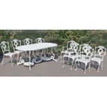 A Victorian-style white painted aluminium twin-pedestal garden table with rounded ends to the