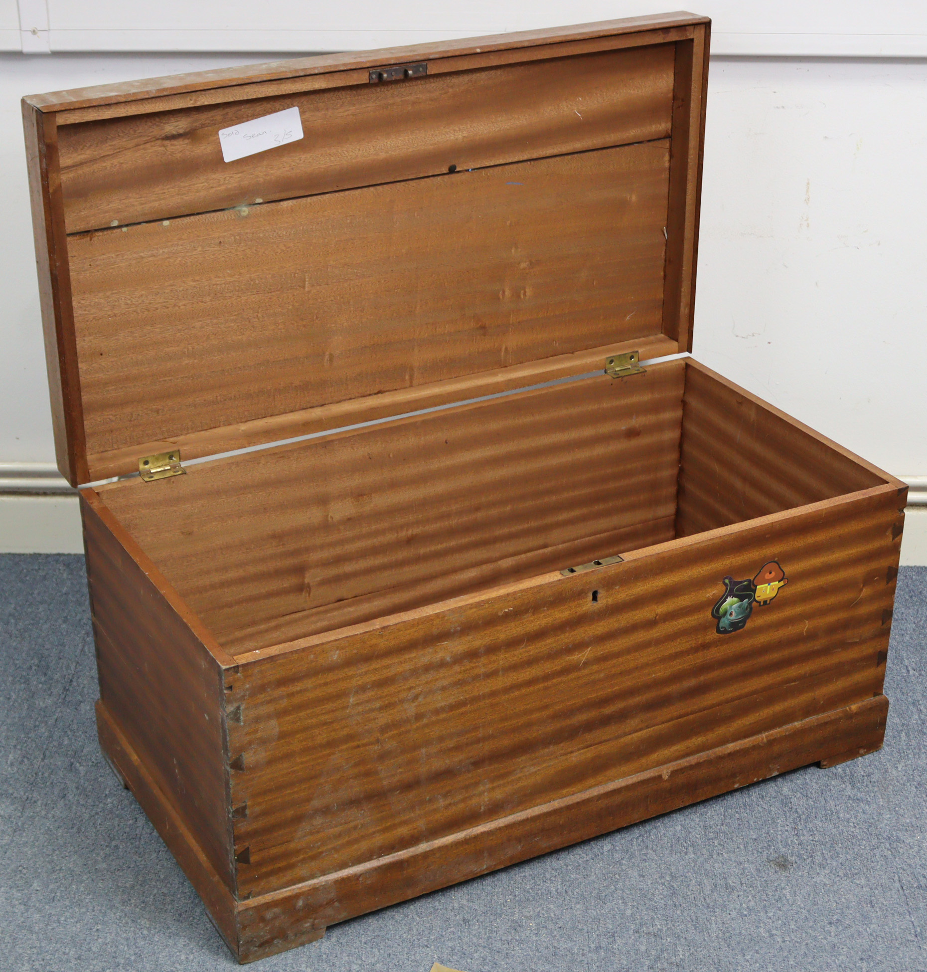 A mahogany storage trunk with hinged lift lid & on block feet, 33½” wide x 16¼” high.