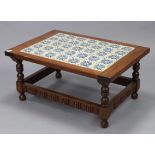 A Mexican low rectangular coffee table inset blue & cream painted tiles to the top, on turned