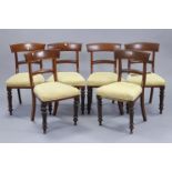 A set of six William IV mahogany bow-back dining chairs with padded seats, & on turned tapered