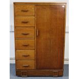 A mid-20th century oak gent’s wardrobe, enclosed by panel door to the right-hand side, fitted six