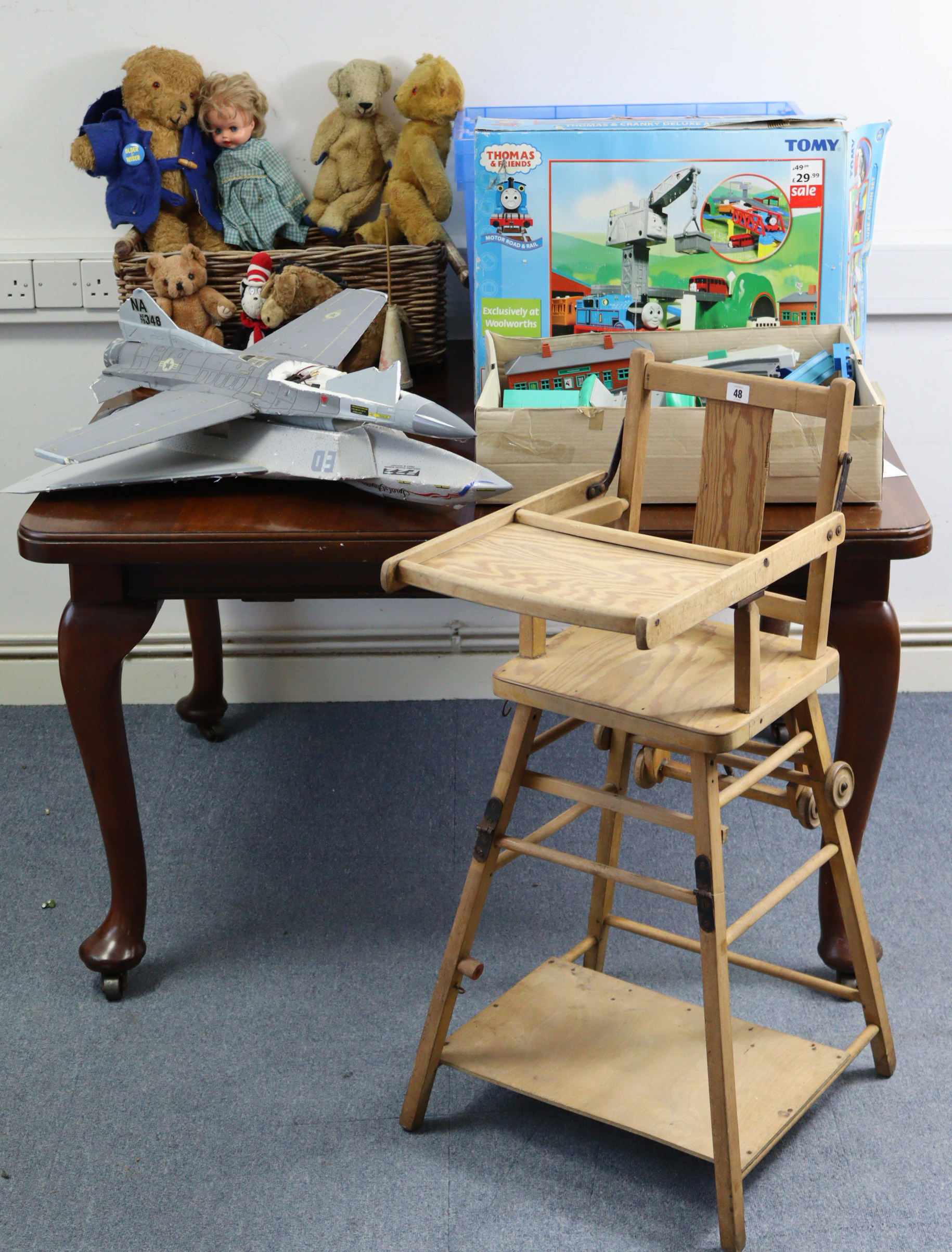 A child’s wooden high/low chair; together with numerous soft toys; a Thomas The Tank Engine train