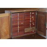 A Victorian mahogany coin collector’s cabinet, part fitted with forty sliding trays enclosed by pair