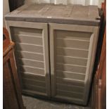 A small brown & grey plastic garden storage unit enclosed by pair of doors, 29¼” wide x 36” high;