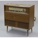 A Grundig radiogram in mahogany-finish case, & on short round tapered legs, 30¾” wide x 32” high.