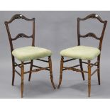 A pair of late 19th century carved beech rail-back occasional chairs with padded seats, & on